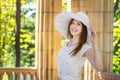 Loughing woman in white hat