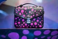 Louis Vuitton collaboration line with Japanese artist and sculptor Yayoi Kusama black and pink bag in NYC shop.