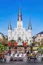 Sunny view of the historical St. Louis Cathedral with many mid centry carriage at French Quarter Royalty Free Stock Photo