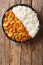 Louisiana shrimp Etouffee with vegetables cooked in roux sauce served with rice closeup in a plate. Vertical top view