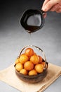 Loukoumades or luqaimat or lokma with syrup in metallic bowl. Popular Ramadan or Ramazan Food. Iftar or Suhur sweets