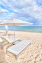 Lounge Chair Beds and Umbrella at White Sandy Beach in Caribbean Royalty Free Stock Photo