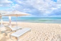 Lounge Chair Beds and Umbrella at White Sandy Beach in Caribbean Royalty Free Stock Photo