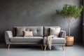 Lounge chair near grey tufted corner sofa in classic room. Scandinavian home interior design of modern living room Royalty Free Stock Photo