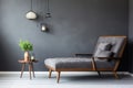 Lounge chair near grey tufted corner sofa in classic room. Scandinavian home interior design of modern living room Royalty Free Stock Photo