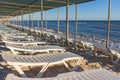 Lounge chairs on the beach. Empty resort. Sun beds under cover on the coast. Idyllic place for summer relaxation. Royalty Free Stock Photo