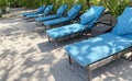 Lounge chairs or beach chairs on white sand beach in hot summer day in luxury tropical hotel Royalty Free Stock Photo