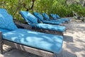 Lounge chairs or beach chairs on white sand beach in hot summer day in luxury tropical hotel Royalty Free Stock Photo