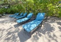 Lounge chairs or beach chairs on white sand beach in hot summer day in luxury tropical hotel Royalty Free Stock Photo