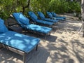 Lounge chairs or beach chairs on white sand beach in hot summer day in luxury tropical hotel Royalty Free Stock Photo