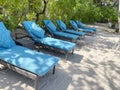 Lounge chairs or beach chairs on white sand beach in hot summer day in luxury tropical hotel Royalty Free Stock Photo