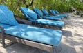 Lounge chairs or beach chairs on white sand beach in hot summer day in luxury tropical hotel Royalty Free Stock Photo