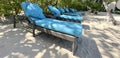 Lounge chairs or beach chairs on white sand beach in hot summer day in luxury tropical hotel Royalty Free Stock Photo
