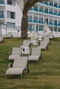 Lounge chairs on the lawn near the hotel close up. vertical