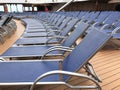 Lounge chairs lined up a cruise ship deck