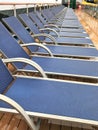 Lounge chairs lined up a cruise ship deck