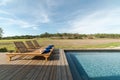 Lounge chairs in modern villa pool Royalty Free Stock Photo