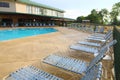 Lounge chairs in the pool edge Royalty Free Stock Photo