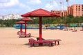 Lounge chairs with and umbrellas on the beach shortly after the beaches reopened following COVID-19 closures.