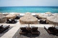 Lounge chairs with umbrellas on the empty White beach, Santorini Royalty Free Stock Photo