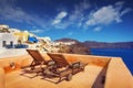 Lounge chairs with a view of the caldera, Oia village, Santorini Royalty Free Stock Photo