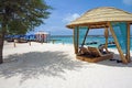 Lounge chairs on white sand beach