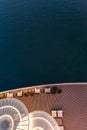 Lounge promenade deck on cruise ship. Interior of luxury cruise restaurant with tables and armchair in sunset at sea Royalty Free Stock Photo