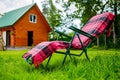 Lounge seat in country side. Green grass lawn and house