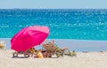 Lounger chairs and parasol umbrellas on sandy beach in Cape Town