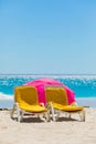 Lounger chairs and parasol umbrellas on sandy beach in Cape Town