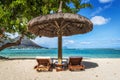 Loungers and umbrella on tropical beach in Mauritius