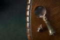 Loupe close-up, vintage magnifier handmade on dark wooden table background, concept of search, investigation, private detective, Royalty Free Stock Photo