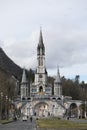 Lourdes sanctuary in winter against the backdrop of the Pyrenees mountains