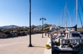 LOUTRA, Greece. Pier in Loutra Marina Kythnos with sailing boats moored, lanterns and traditional greek whitewashed houses. Royalty Free Stock Photo