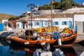 LOUTRA, Kythnos, Greece. Colorful old wooden fishing boat moored at the pier in Loutra Marina Kythnos, Cyclades Islands Royalty Free Stock Photo