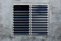 Louver window on gray concrete wall