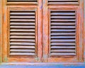 Louvered closed window shutters. Royalty Free Stock Photo