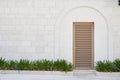 louvered plastic door on the stone wall Royalty Free Stock Photo