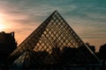 Louvre pyramid silhouette dramatic sky