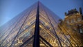 Louvre art museum with glass pyramid construction, sightseeing in Paris, France