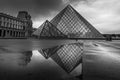 Louvre museum in black and white with reflection in a puddle. Louvre museum is one of the world`s largest museums with more than Royalty Free Stock Photo