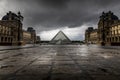 Louvre museum in black and white with reflection in a puddle. Louvre museum is one of the world`s largest museums with more than Royalty Free Stock Photo