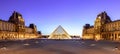 Louvre museum at night wide angle, is the world`s largest art museum and a historic monument in Paris, France. Royalty Free Stock Photo