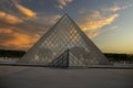 The Louvre museum in Paris under a beautiful sunset sky creating a beautiful backdrop with the Seine river of France Royalty Free Stock Photo