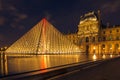 Louvre Museum and the Pyramid in Paris, France, at night illumi Royalty Free Stock Photo