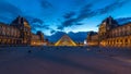 The Louvre museum pyramid after sunset day to night timelapse in Paris, France Royalty Free Stock Photo