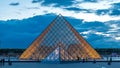 The Louvre museum pyramid after sunset day to night timelapse in Paris, France Royalty Free Stock Photo