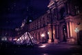 Louvre, night view. Dark background with architecture.