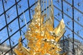 louvre in paris gold statue blue sky