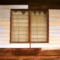 Louvred windows in a rustic boarded dwelling Royalty Free Stock Photo